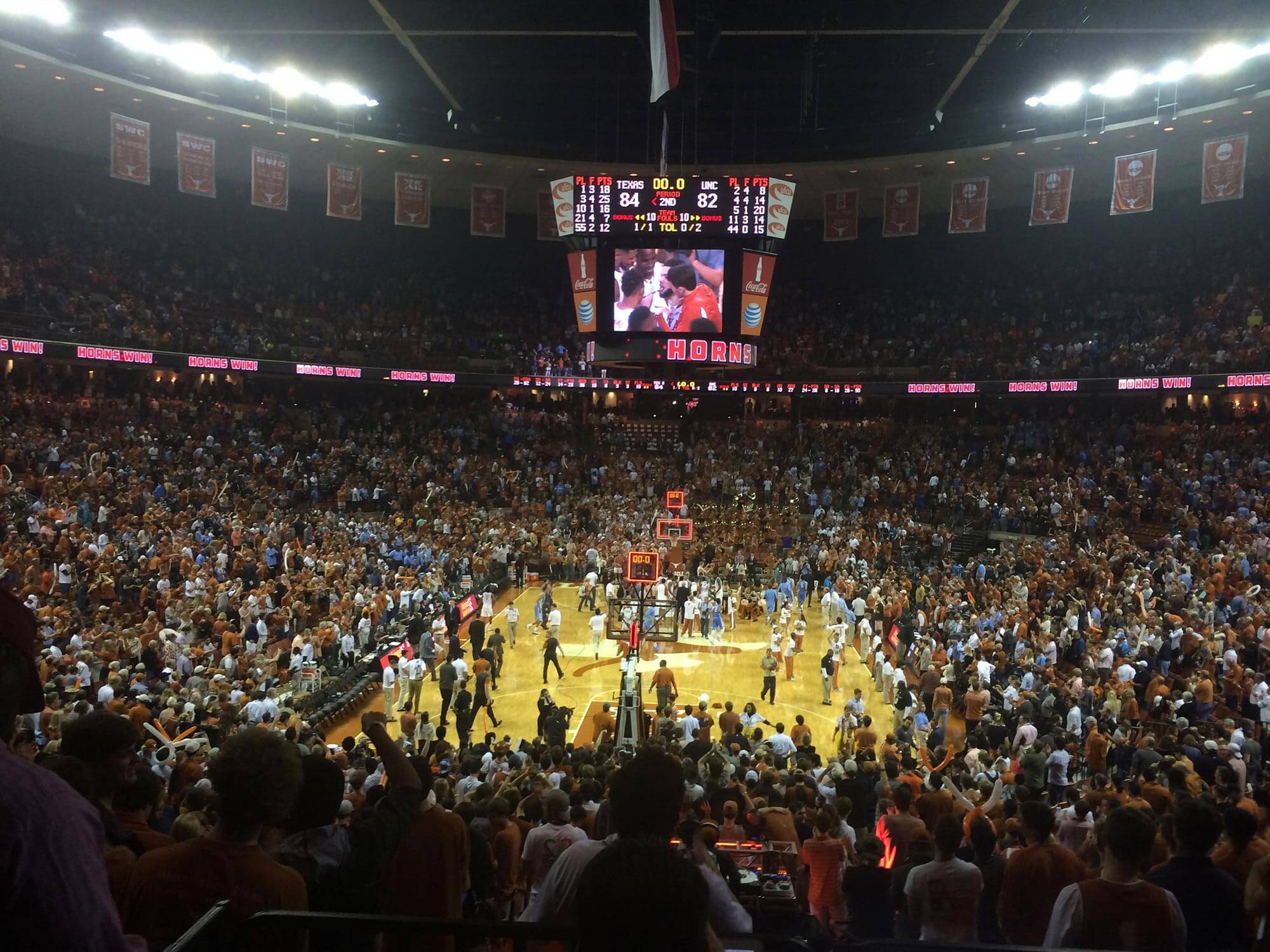 Texas men's basketball and fans celebrate a win over North Carolina at the Frank Erwin Center