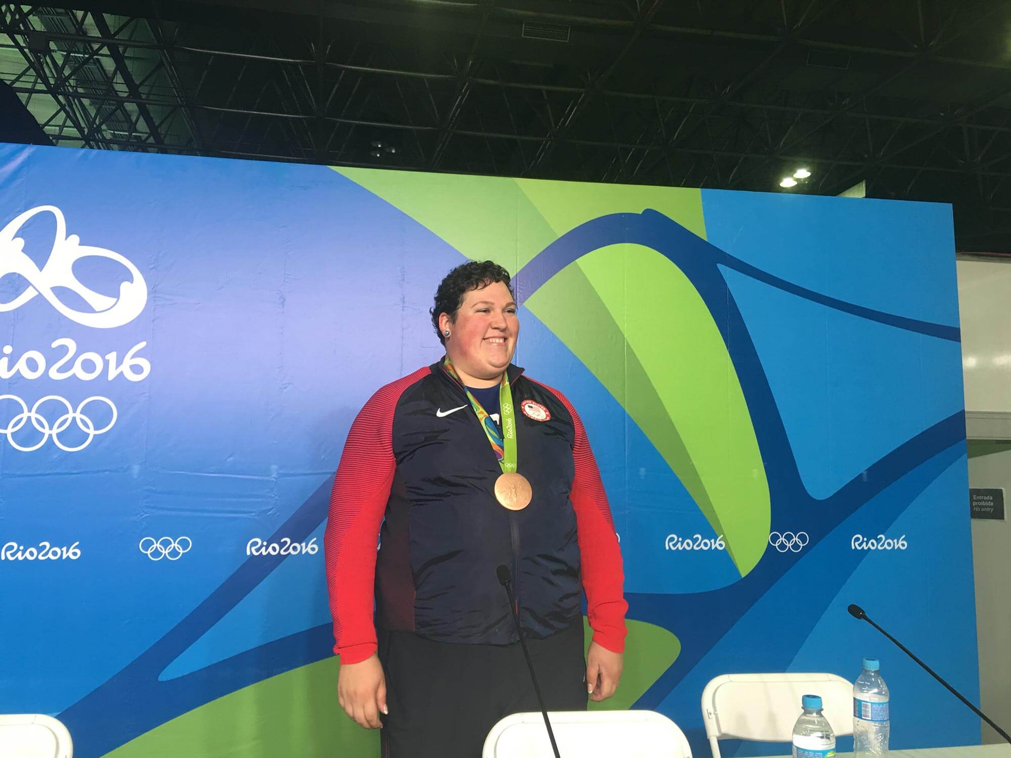 Olympic woman weightlifter posing with bronze medal