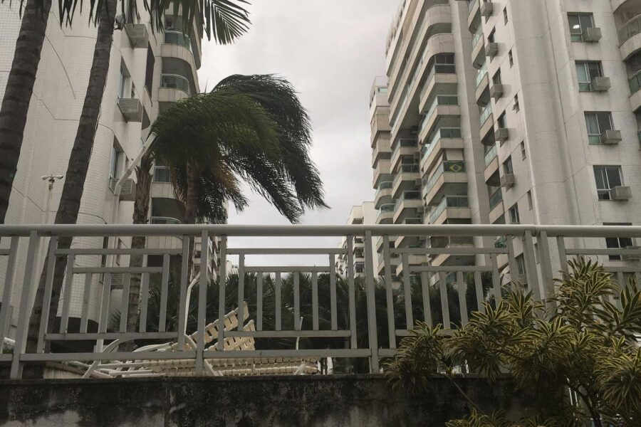 Palm trees bend in the wind at an apartment complex in Rio de Janeiro, Brazil