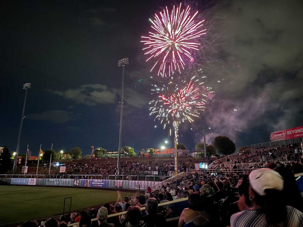 Red, white and bllue fireworks over a baseball stadium