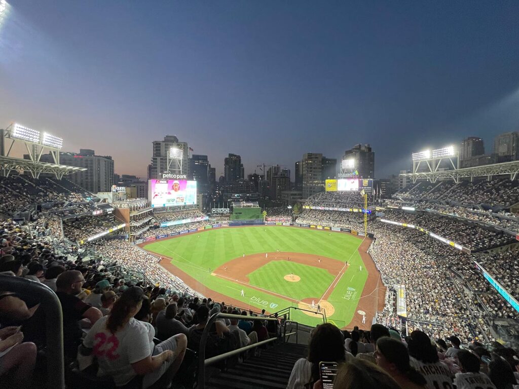 A view of the Petco Park baseball stadium looking out at downtown San Diego at dusk