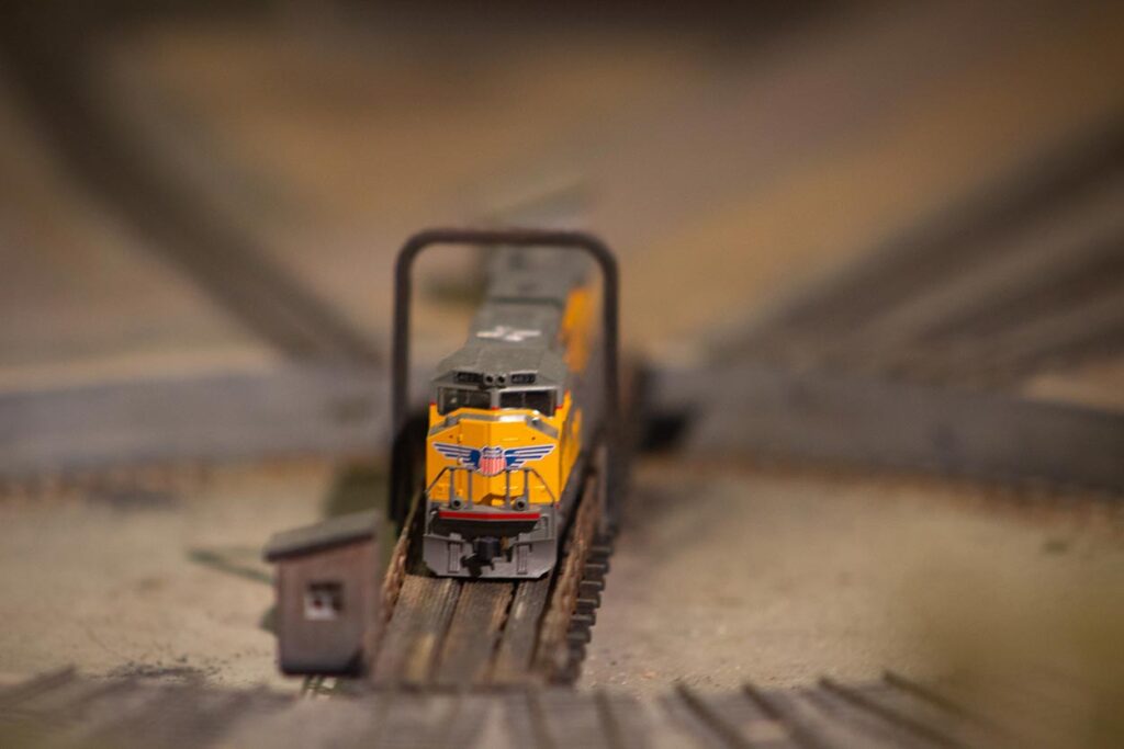 A Union Pacific train engine sitting on a turntable on a model train layout