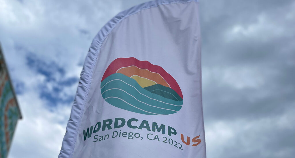 A banner with the WordCamp US logo flapping in the wind