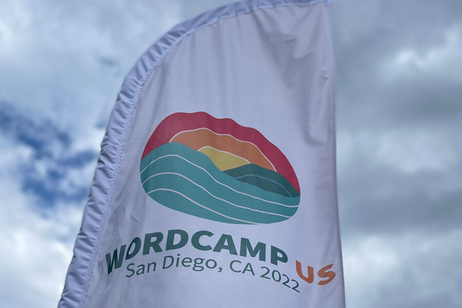 A banner with the WordCamp US logo flapping in the wind