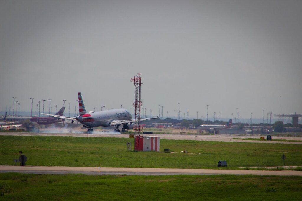 An American Airlines plane landing at an airport
