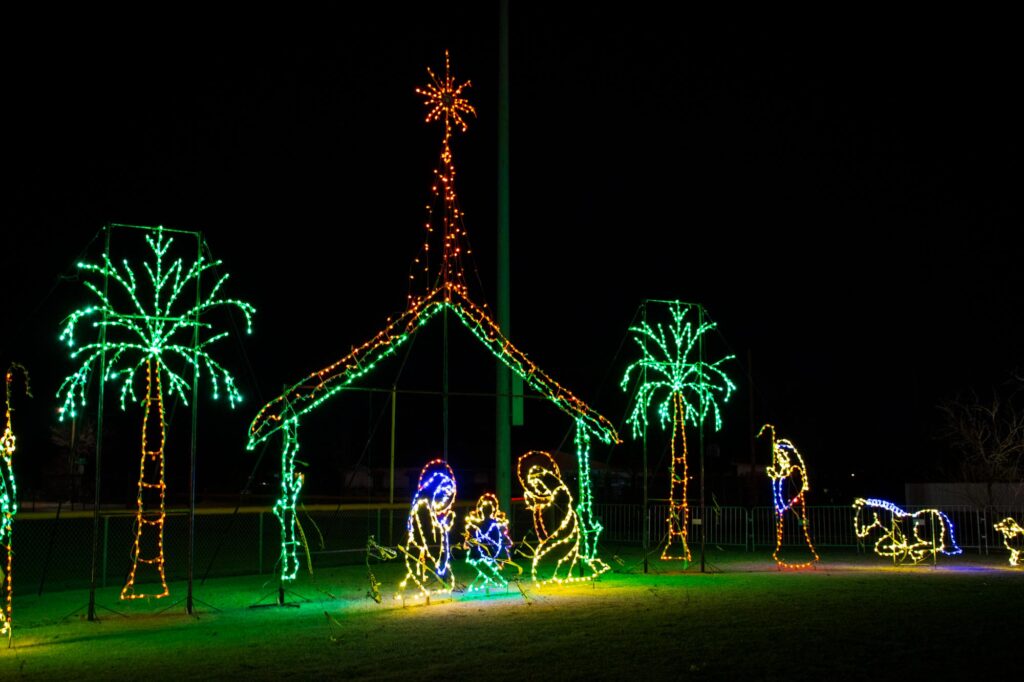 Colored lights in a park at night depicting the manger scene