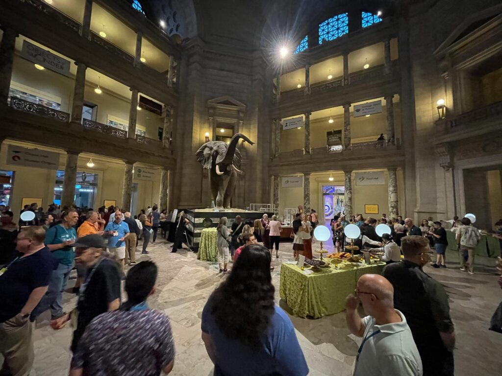 A large atrium with people and a fake elephant