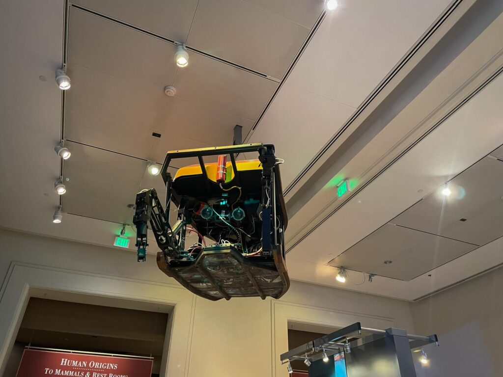 A deep sea rover hanging from the ceiling in a museum
