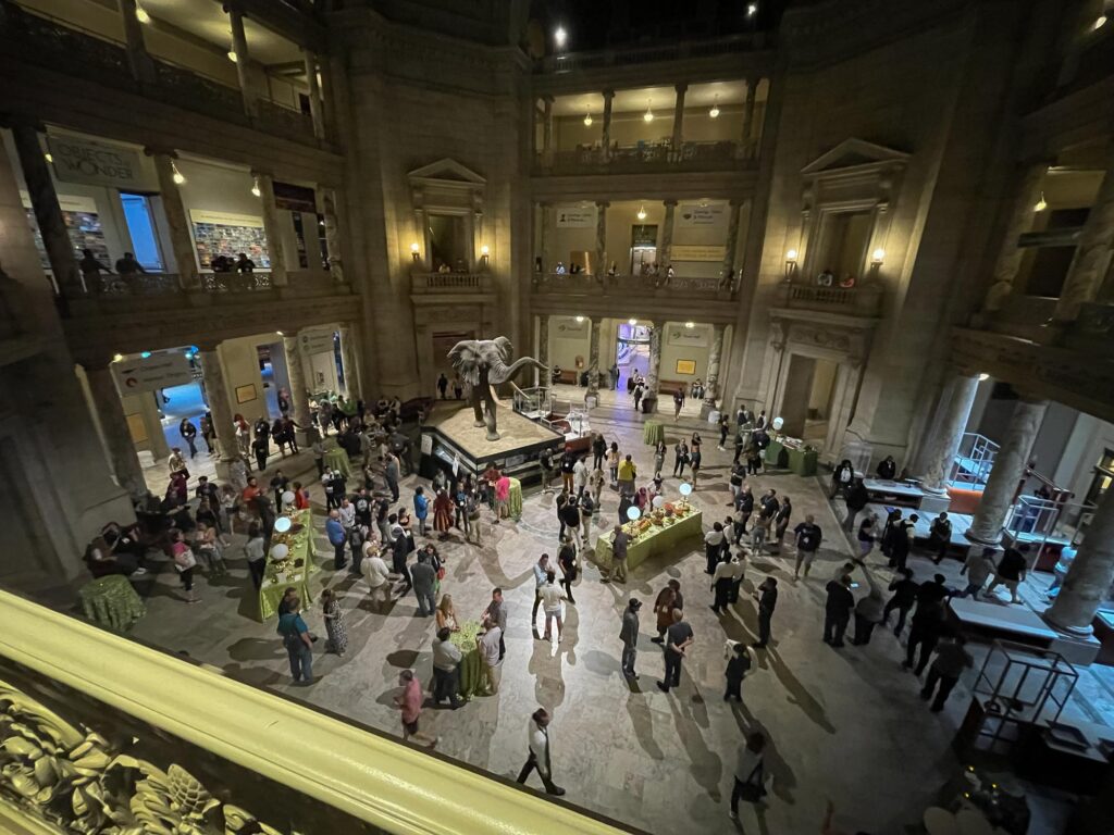 A large atrium filled with people and an elephant viewed from above