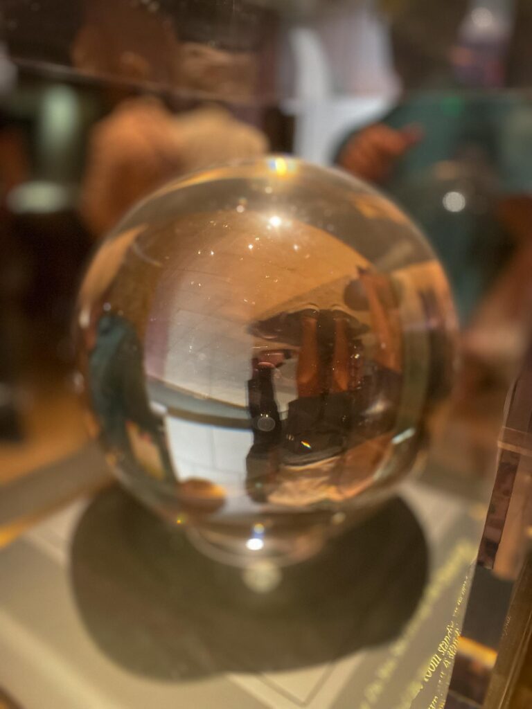 A perfect sphere gemstone in a glass case in a museum exhibit