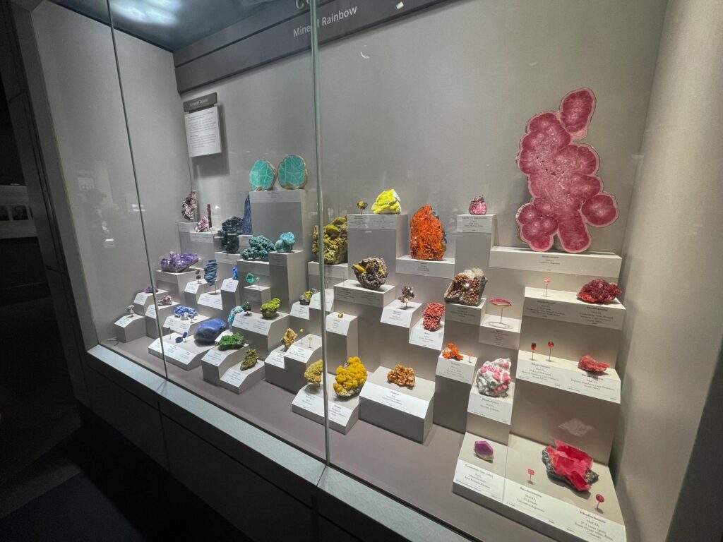Colorful diamonds and gemstones in a glass case in a museum exhibit