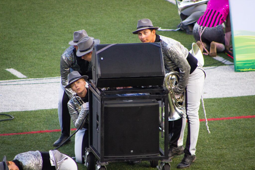 Members of a drum corps acting like mice before a show