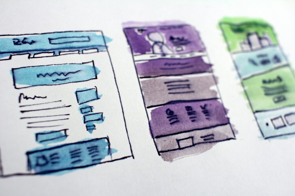 blue, green and purple sketched out wire frames for websites