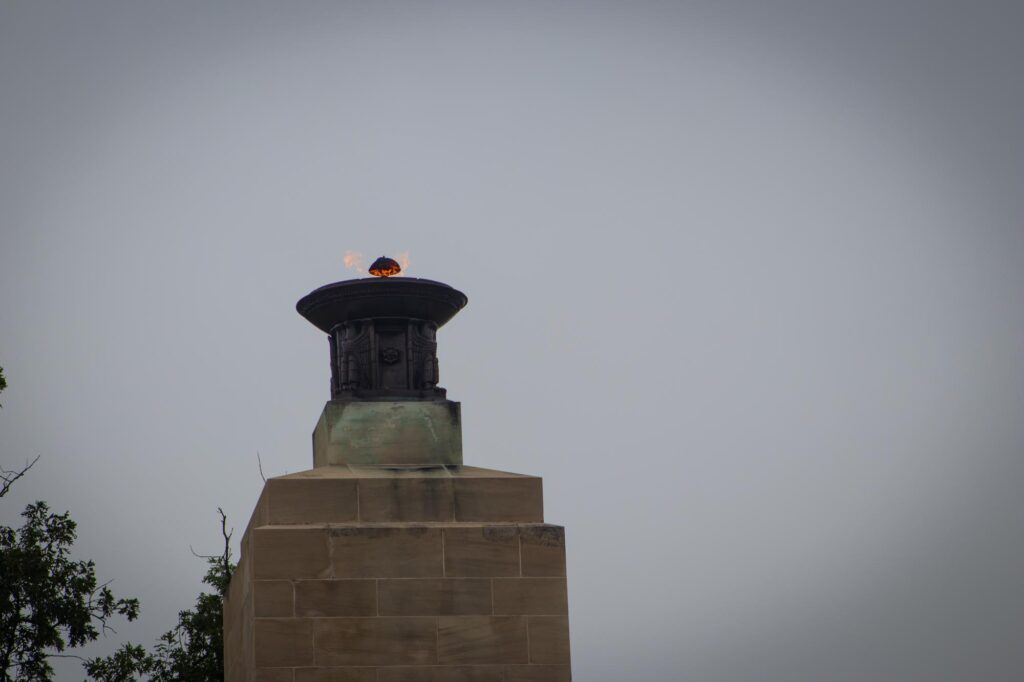 An eternal flame at the top of a memorial tower