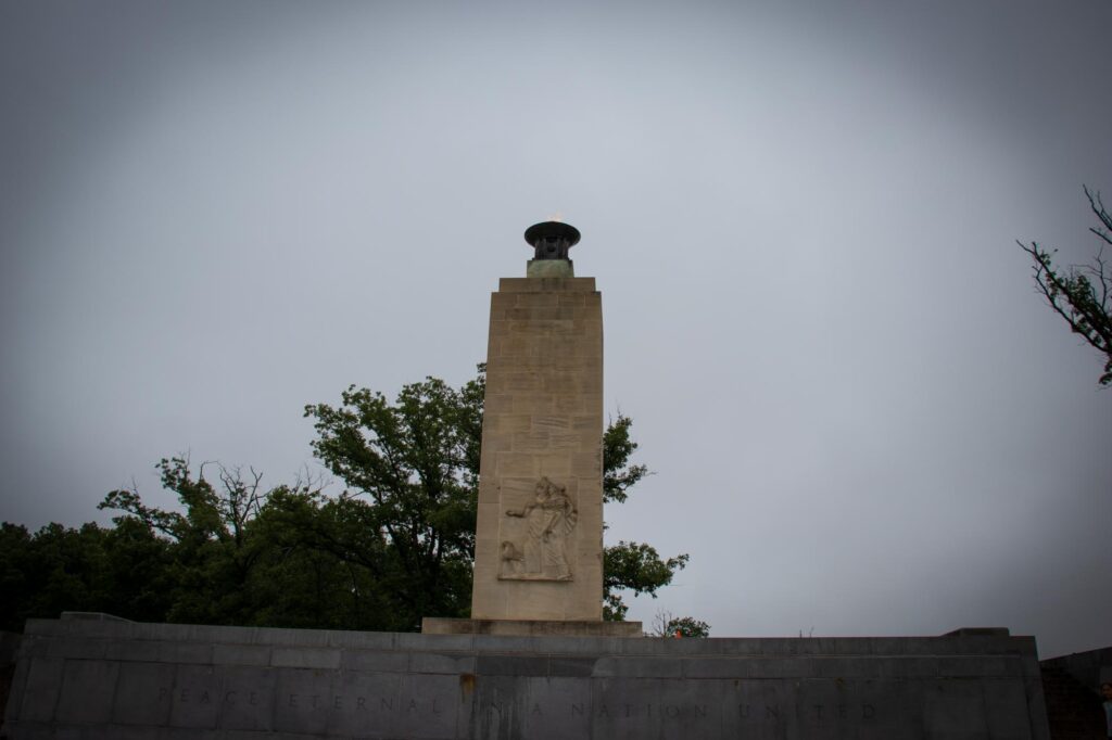 A small memorial tower with an eternal flame at the top