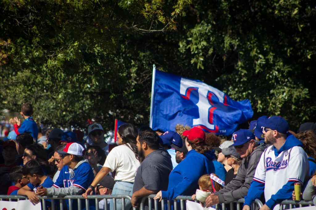 A Texas Rangers flag flying at a parade