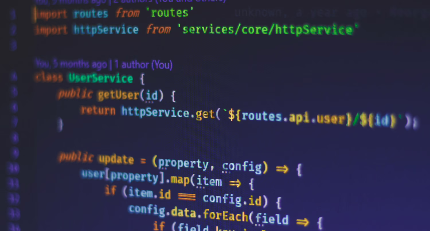 A close-up of a code editor displaying JavaScript with a UserService class, showing methods for fetching and updating user data, with git blame annotations in the gutter.